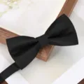 Black men's herringbone bow tie detail shot, perfect for formal business events and weddings. - Black Wavy Bow Tie