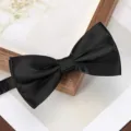 Detail shot of a classic black satin bow tie, elegant formal accessory for wedding suit. - Classic Black Bowtie