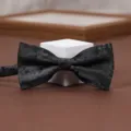 Close-up view showing the exquisite black textured fabric and classic shape of the fashion bow tie. - Dark Night Peony Bow Tie