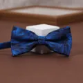 Blue jacquard bow tie detail shot showing intricate leaf pattern fabric and elegant texture. - Dreamy Nebula Bow Tie