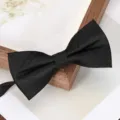 Close-up detail of a classic black bow tie with subtle textured grid pattern for men. - Black Diagonal Plaid Bowtie