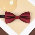 Close-up detail of the wine red herringbone bow tie showing delicate fabric texture and form. - Wine Red Wave Bowtie