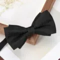 Classic black textured bow tie for men, elegant formal wear accessory for weddings and business. - Black Asymmetric Paisley Bowtie
