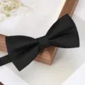 Elegant black bow tie with fine texture detail for formal wear and business events close-up. - Gentleman Black Bow Tie