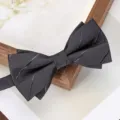 Close-up detail of a dark grey men formal bow tie with classic twill texture, perfect for weddings. - Dark Gray Asymmetric Stripe Bowtie