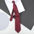 Red zipper tie with geometric square pattern displayed on a clean white shirt for formal wear. - 8cm Burgundy Square Zipper