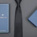 Detailed view of the dark textured necktie with blue gift box, perfect for business wear. - Striped Zipper Style (Long Gift Box) / 8cm Wide / Classic Black