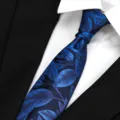 Close-up of blue leaf patterned men business tie detail texture and knot styling. - Fantasy Nebula