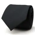 Close-up of black men's business suit necktie with subtle diagonal stripe texture detail. - 8cm Black Meteor Hand-Tied