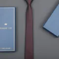Close-up detail of the maroon slim necktie paired with an elegant blue gift box packaging. - 6cm Elegant Burgundy Zipper (With Long Gift Box)