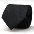 Close-up detail of a classic black necktie featuring an elegant woven paisley pattern for formal wear. - 8cm Black Paisley Hand-Tied