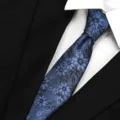 Blue floral patterned men tie detail close up shot for formal business suit and white shirt style - Cloud Yarn Gray Blue