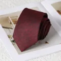 Close-up detail view of a dark red textured men's necktie, rolled neatly on a white surface. - 8cm Handmade Style / Rouyunxian Wine Red