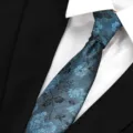 Detailed close-up view of the stylish blue floral necktie, showing fabric texture. - Colorful Gray Green