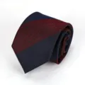 Detailed view of a classic red and blue striped men's necktie, perfect for business formal attire. - Burgundy and Navy Wide Stripe