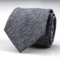Detailed view of a stylish dark grey textured men business suit tie with subtle white speckles. - 8cm Starry Gray Hand-Tied