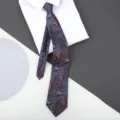 Close-up detail of a blue paisley patterned zipper necktie displayed on a crisp white shirt. - 8cm Royal Consort Zipper