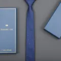 Close-up detail of a classic blue business necktie with white dot pattern and gift box. - 6cm Wavy White Dot Zipper (With Long Gift Box)