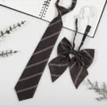 Close-up detail of dark brown striped JK school uniform tie and bow set with adjustable strap. - Dark Champagne Gold Stripe