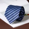 Close-up detail of classic striped necktie fabric texture and folded design for formal wear. - Hand-Tied / 8cm / Blue (A02)