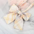 Detailed shot of yellow purple plaid JK bow ribbon, perfect for Japanese school uniform shirt. - Lemon Yellow Plaid