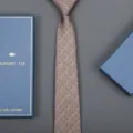 Close-up detail of a classic brown dotted men tie paired with a luxury blue gift box. - Dot Zipper Style (Long Gift Box) / 8cm Wide / Champagne