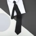 Classic black solid textured business necktie paired with white shirt display variant item. - 8cm Black Fine Stripe Zipper