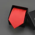 Detailed view of a classic red men's tie neatly folded inside a black gift box, elegant accessory. - 8cm Red Solid Self-tie Without Box