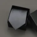 Detailed view of a classic grey business tie in a black gift box, perfect for formal suits and weddings. - 8cm Dark Grey Solid Self-tie Without Box