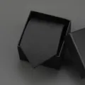 Detailed view of a black business tie with subtle diagonal stripes, elegantly packaged in a box. - 8cm Black Meteor Zipper Without Box