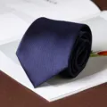 Detail shot of a classic navy blue men's necktie, perfect for business and formal wear events. - Smooth Hand-Tied Style / 8cm / Navy Blue