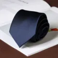 Close-up detail of a rolled navy blue twill men formal business necktie on desk scene. - Fine Stripe Self-Tie / 8cm / Dark Navy