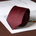 Close-up of a dark red textured necktie, stylish grid pattern fabric for business formal wear. - Plaid Hand-Tied / 8cm / Burgundy