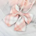 Closeup of pink white plaid JK bow tie detail, sweet Japanese school uniform collar ribbon accessory. - Light Orange Plaid