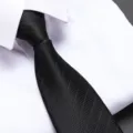 Detail shot of a classic black textured necktie paired with a crisp white dress shirt. - 8cm Elegant Black Stripe Zipper