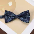 Detail shot of dark blue floral woven bow tie, elegant men's suit accessory for formal wear. - Aegean Wave Navy Blue Bow Tie