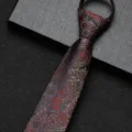 Close-up detail of a dark paisley pattern zipper tie, featuring intricate red floral motifs on textured fabric. - 8cm Auspicious Cloud Phoenix Zipper Style