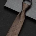 Gedetailleerde close-up van de bruine stropdas met ritssluiting en blauw stippenpatroon, textuur. - 8cm Champagne Stipjes Rits Stijl