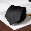 Detail view of a stylish black pleated men necktie, perfect for formal business and wedding events. - Bold Striped Hand-Tied / 8cm / Black