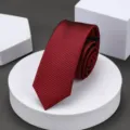 Close-up shot of a stylish red and black striped narrow tie, neatly rolled on display block. - 6cm Burgundy Classic