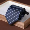 Detail view of a navy blue striped zipper tie, showing the neat roll and texture clearly. - 8cm Stripe Zipper Style (A080) / Dark Blue