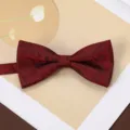 Detailed view of a dark red jacquard bow tie with subtle leaf pattern for men's business suit. - Burgundy Pine Shadow Bow Tie