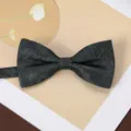 Detailed close-up of dark herringbone textured men's bow tie with elegant jacquard fabric. - Soft Cloud Pavilion-Dark Green Bow Tie
