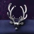 Close-up of a vintage silver deer head brooch, detailed with sparkling rhinestones on antlers. - Silver Diamond Elk
