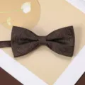 Detailed close-up view of a brown retro jacquard mens bow tie with fine floral pattern. - Dark Brown Pine Shadow Bow Tie