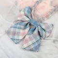 Detailed close-up view of a Japanese JK plaid bow tie collar accessory with elegant streamers. - Blue Pink Plaid