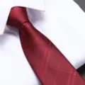 Detailed shot of a classic red men's formal business tie with textured diagonal plaid. - Burgundy Large Plaid Zipper