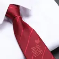 Close-up detail of a red wedding tie with double happiness embroidery and zipper design. - Festive Red Zipper