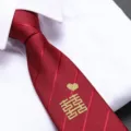 Close-up detail of red wedding tie with traditional golden double happiness embroidery. - Golden Joyful Expression Zipper