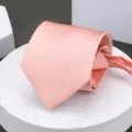 Elegant pink men's necktie, neatly rolled display on a white platform for business wear. - Lotus Pink Zipper Necktie